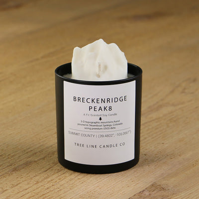  A white soy wax replica candle of Breckenridge Peak 8  in a round, black glass.