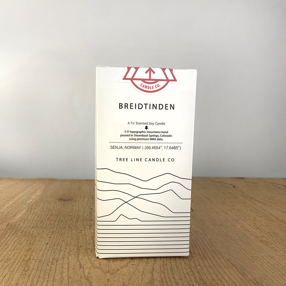 A white box with black lettering and a red and white Tree Line Candle Co.  logo.