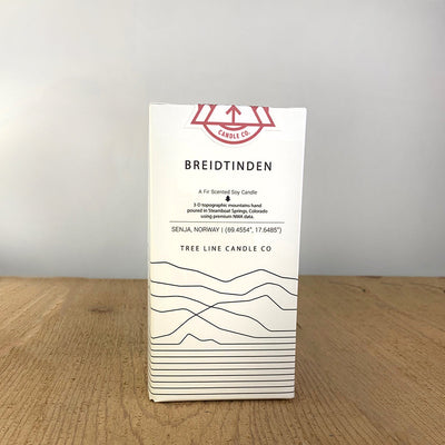 A white box with black lettering and a red and white Tree Line Candle Co.  logo.