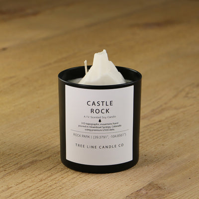  A white soy wax replica candle of Castle Rock in a round, black glass.