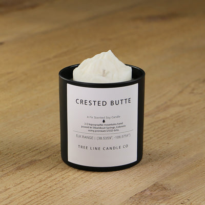  A white soy wax replica candle of Crested Butte in a round, black glass.