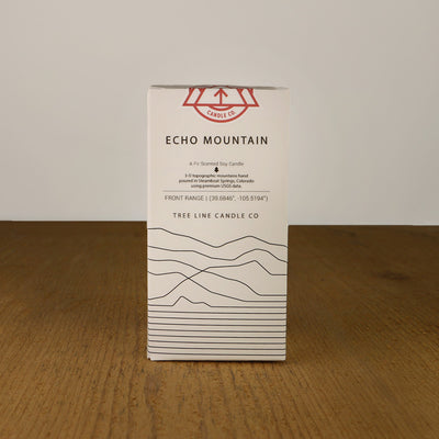 A white box with black lettering and a red and white Tree Line Candle Co.  logo.