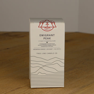 A white box with black lettering and a red and white Tree Line Candle Co.  logo.