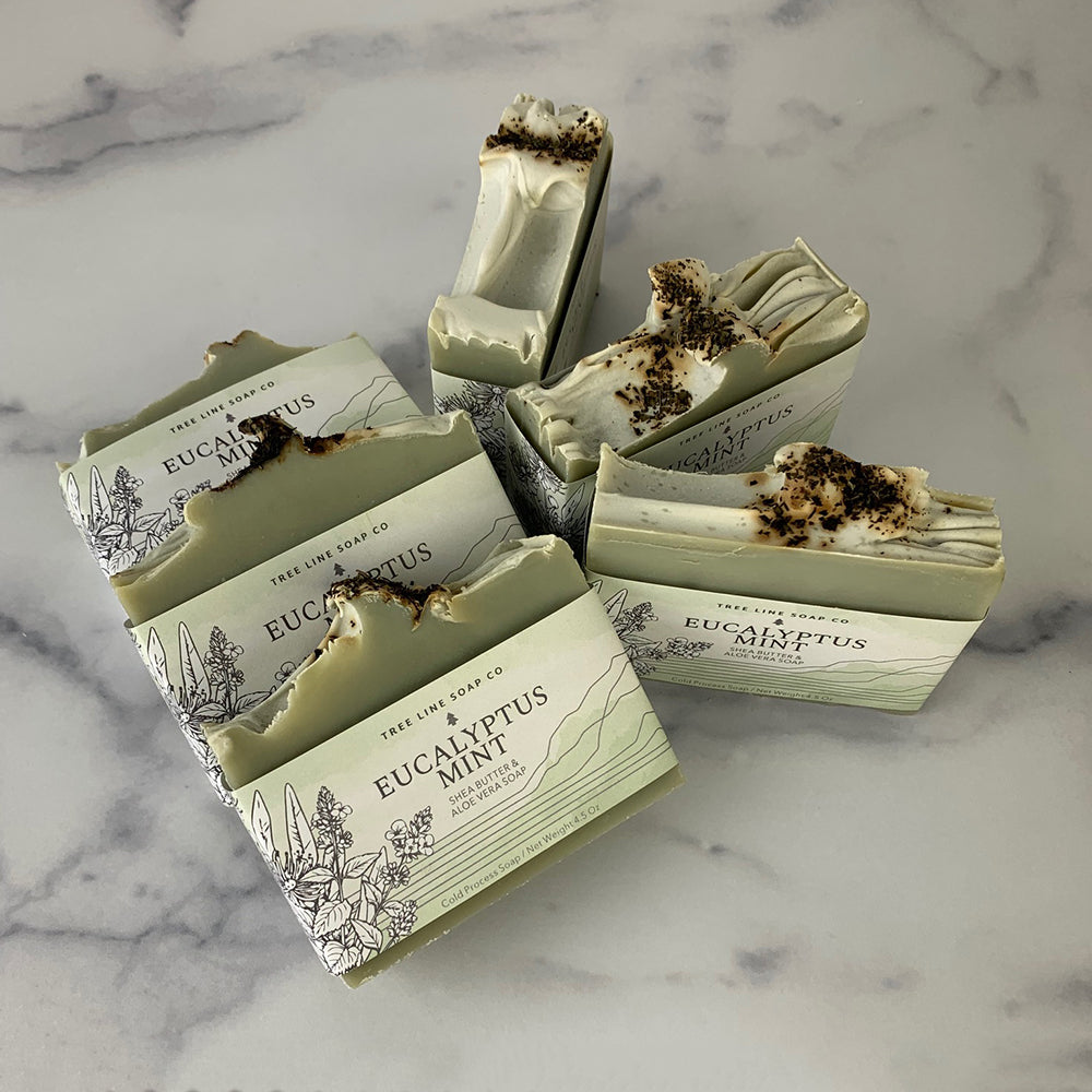 Six bars of Eucalyptus Mint soap are arranged so the tops show.