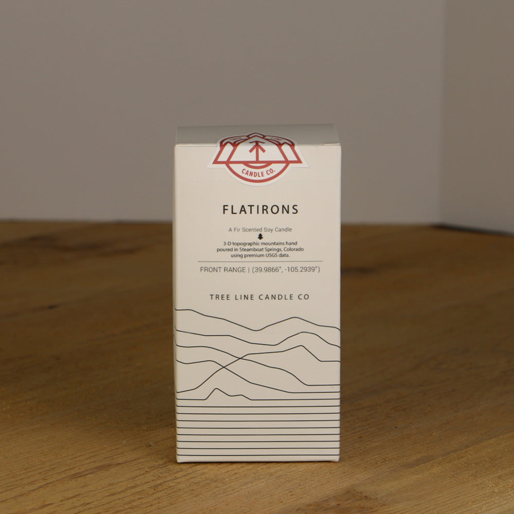 A white box with black lettering and a red and white Tree Line Candle Co.  logo.