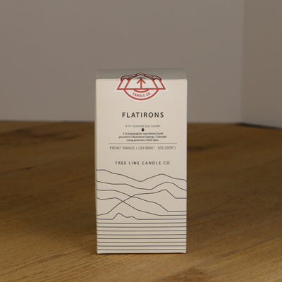 A white box with black lettering and a red and white Tree Line Candle Co.  logo.