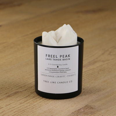  A white soy wax replica candle of Freel Peak in a round, black glass.