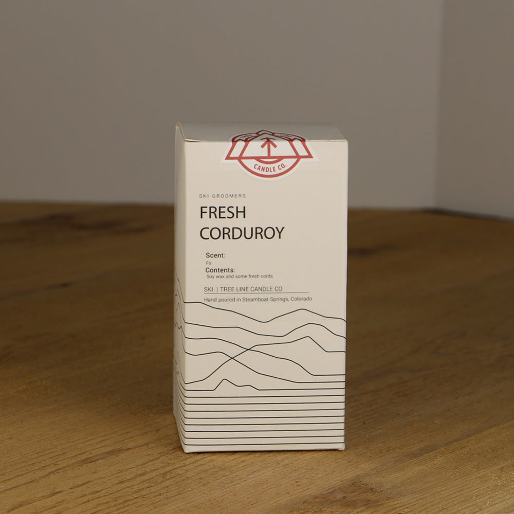 A white box with black lettering and a red and white Tree Line Candle Co.  logo.