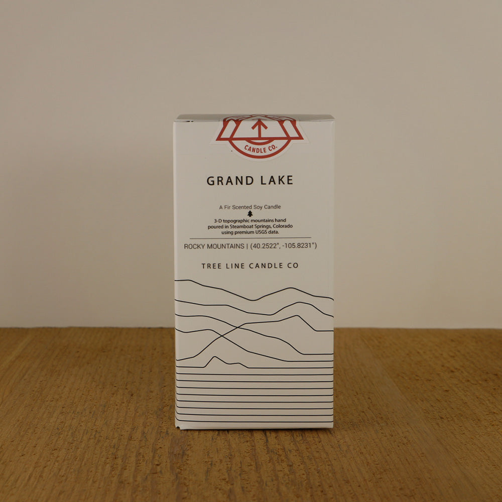 A white box with black lettering and a red and white Tree Line Candle Co.  logo.