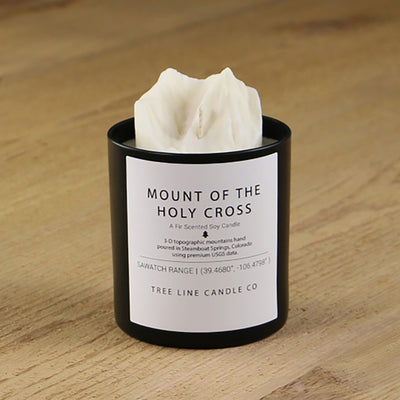  A white soy wax replica candle of Mount of the Holy Cross summit in a round, black glass.