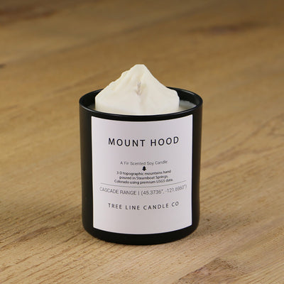  A white soy wax replica candle of Mount Hood in a round, black glass.