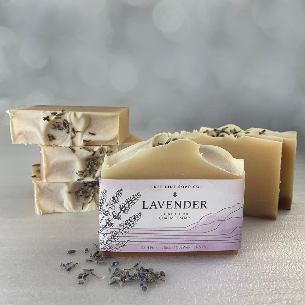 A single bar of Lavender soap is in front of several other lavender soaps as background.
