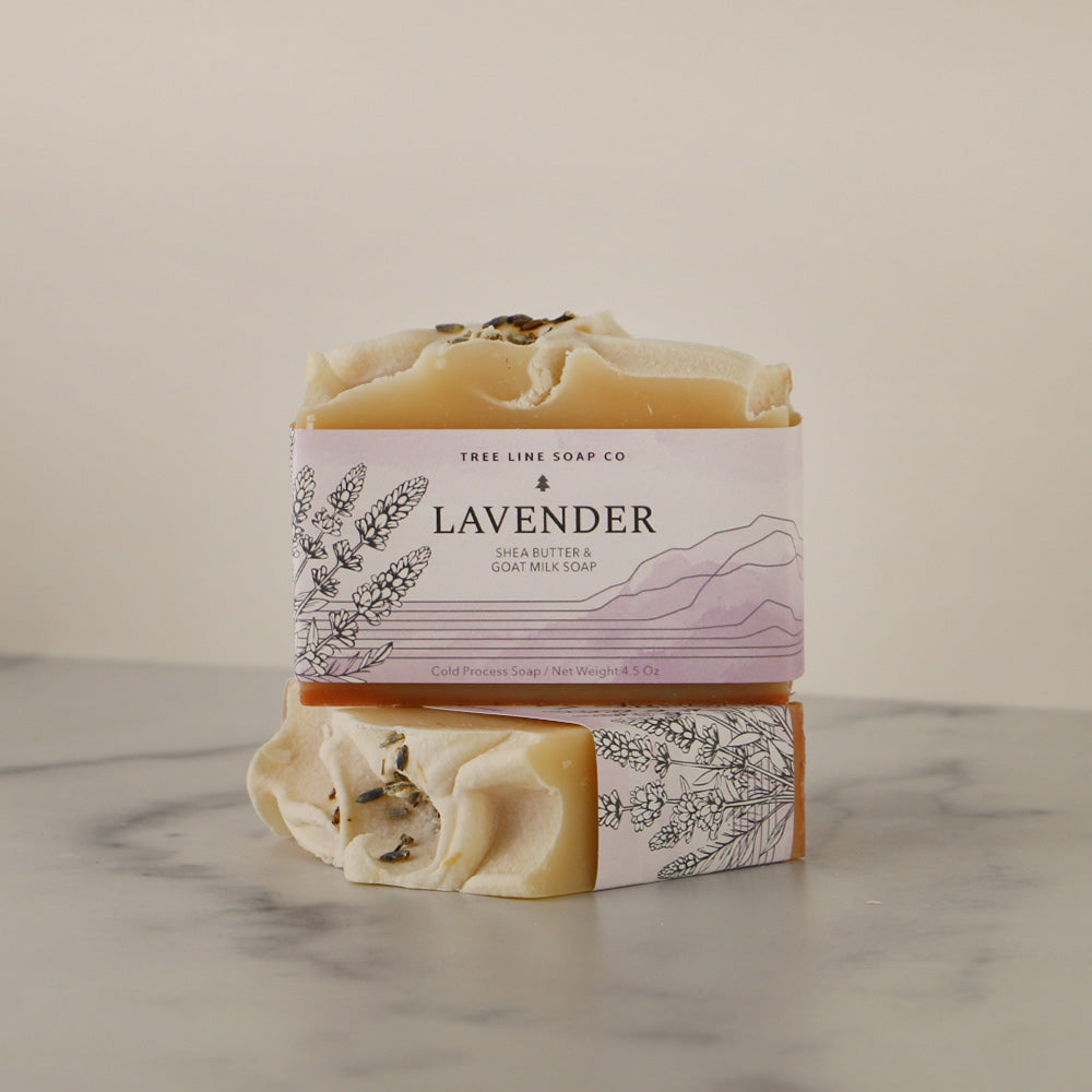 A single bar of Lavender soap sits atop another bar of soap with the same fragrance.