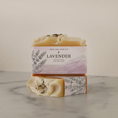 A single bar of Lavender soap sits atop another bar of soap with the same fragrance.