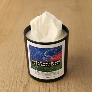  A white soy wax replica candle of Longs Peak in a round, black glass.