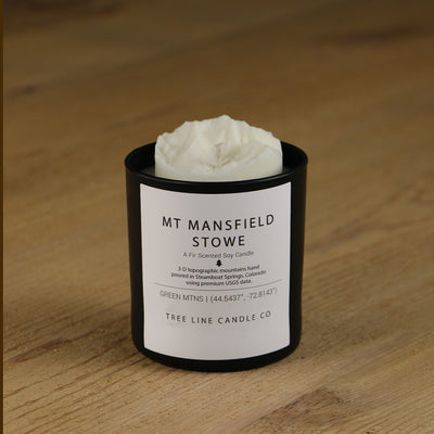  A white soy wax replica candle of Mt. Mansfield Stowe in a round, black glass.
