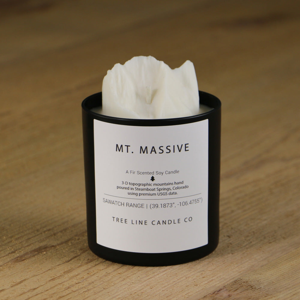  A white soy wax replica candle of Mt. Massive in a round, black glass