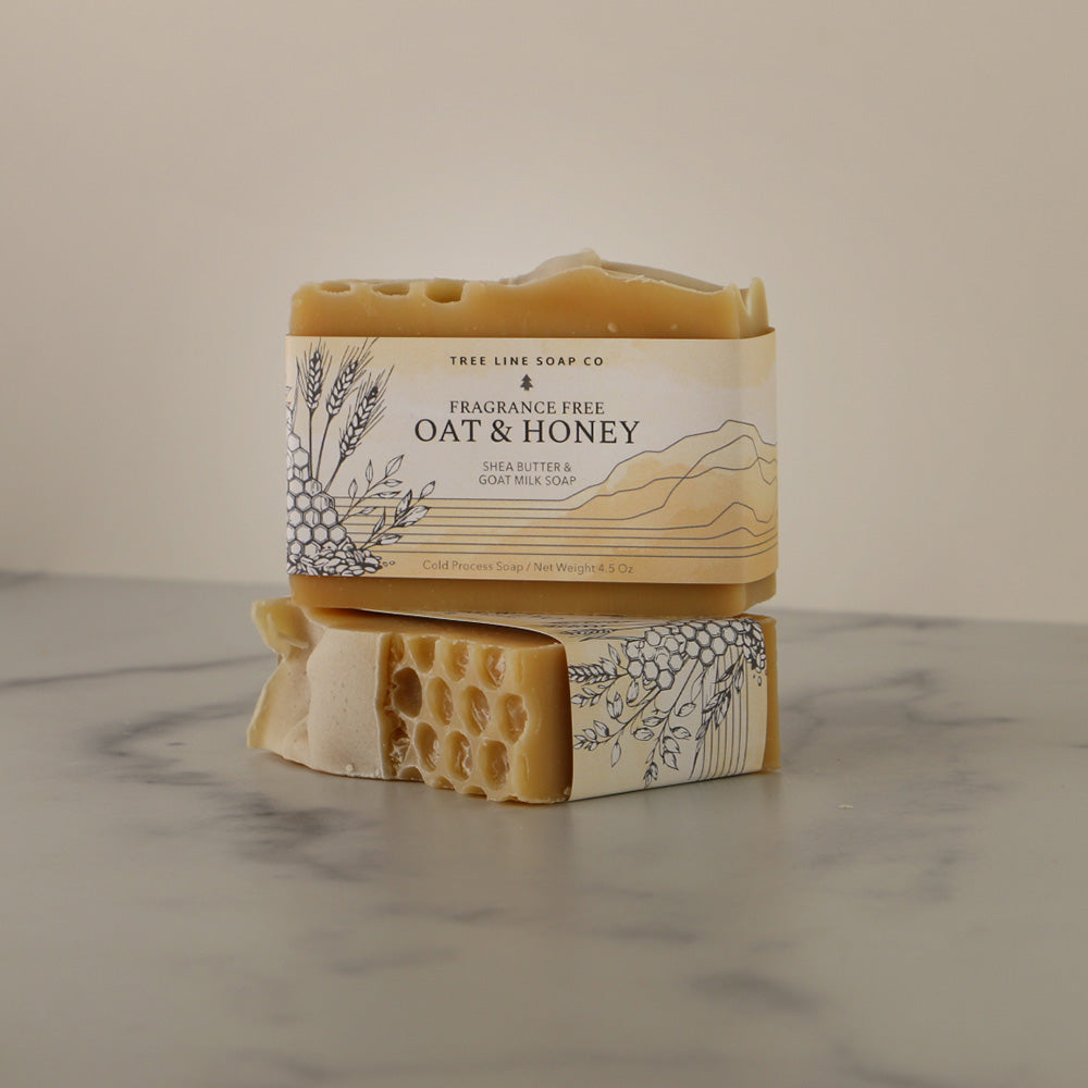 A single bar of Oat & Honey soap sits atop another bar of soap witht the same fragrance.