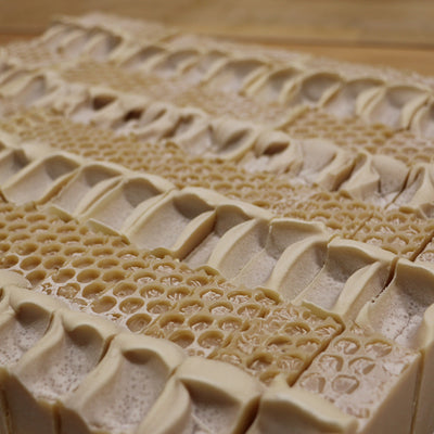 A close view of the tops  of Oat & Honey soaps arrranged in a square.