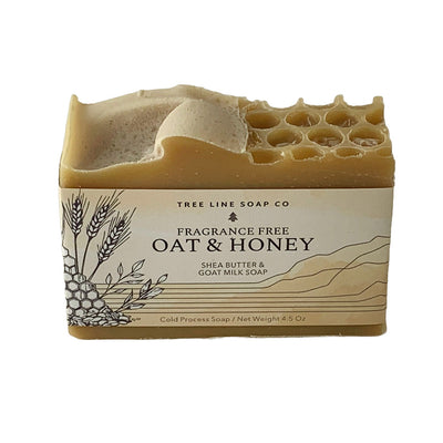 A single bar of Oat & Honey soap is wrapped in a white and beige label.