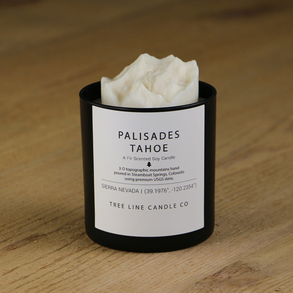  A white soy wax replica candle of Palisades Tahoe summit in a round, black glass.