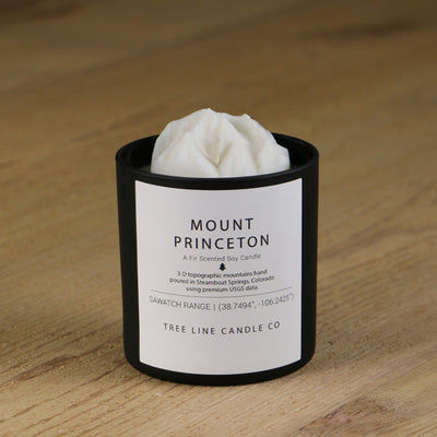  A white soy wax replica candle of Mount Princeton in a round, black glass.