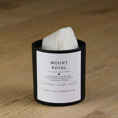  A white soy wax replica candle of Mount Royal in a round, black glass