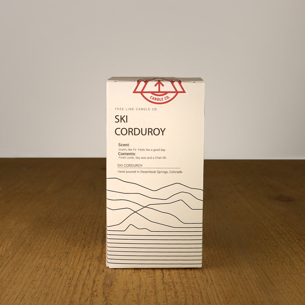 A white box with black lettering and a red and white Tree Line Candle Co.  logo.